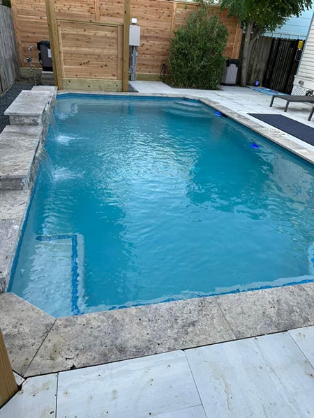 Pool with small waterfall features - pool builder Galveston TX